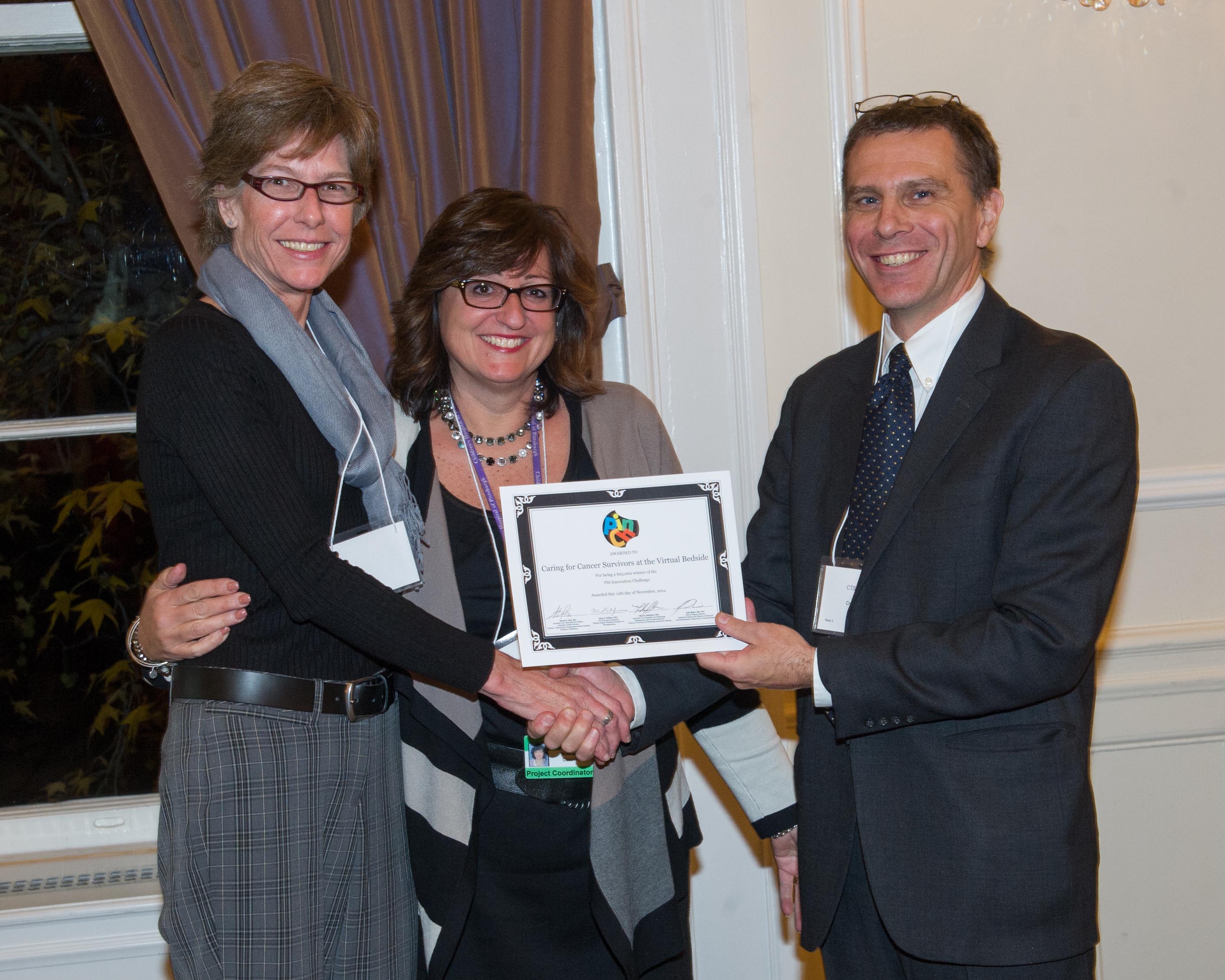 Caring for Cancer Survivors at the Virtual Bedside team holding award