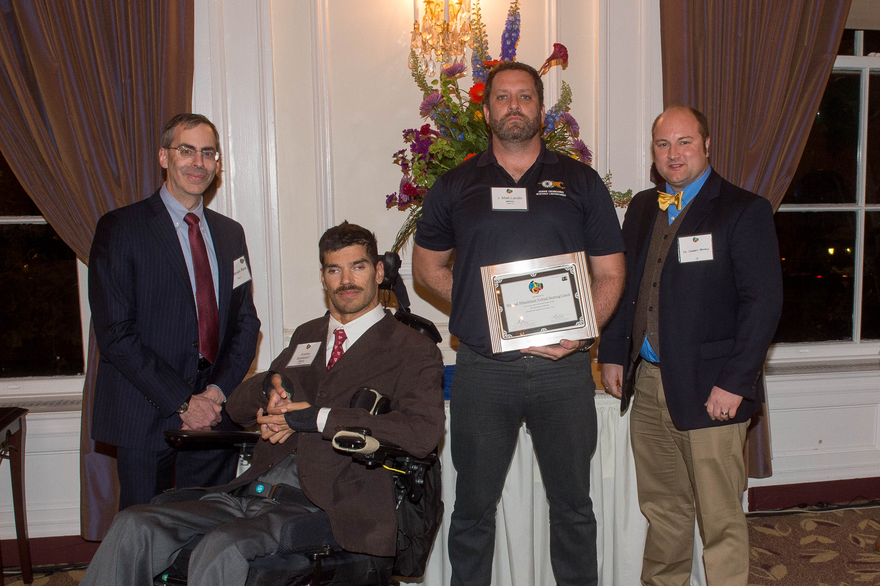 Manual Wheelchair Virtual Seating Coach team holding award